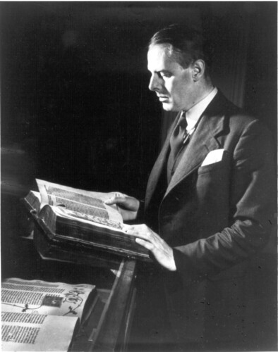 Black and white photo of Richard Pennington with a book.