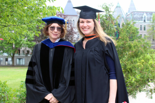 Colleen Cook and Katherine Hanz wearing convocation robes on downtown campus.